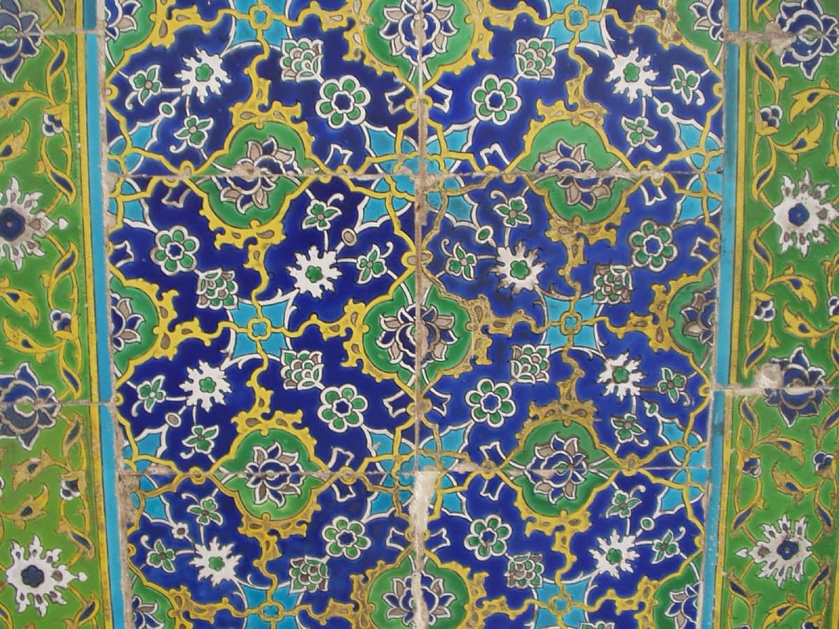 Querformatige Levha: goldene Thuluth-Schrift auf himmelblauem Grund, gerahmt von einem roten Rand mit goldenem Rankenwerk.